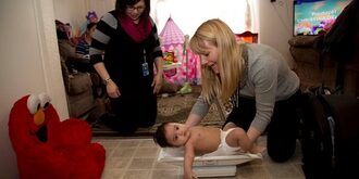 a baby being weighed on a scale