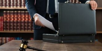 Attorney placing documents in briefcase
