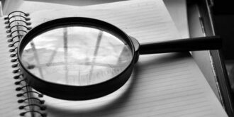 Magnifying glass on notebook