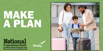 A family of medium skinned individuals look at a map together while holding the handles of rolling luggage carts.