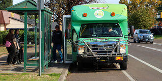 People boarding GroveLink community connector shuttle