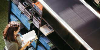 Person looking at items by a supply shelf