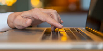 Laptop computers with human hand typing