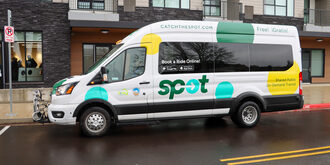 The SPOT shuttle van which is white with yellow, green and aqua polka dots sits in its dedicated pick up parking spot at Amity Orchards