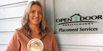 Elly posing with her Community Cares Award