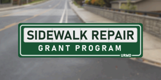 Logo that reads 'sidewalk repair grant program'. Background of blurred out road and sidewalk