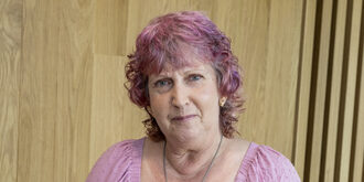 A portrait of a women standing for the camera