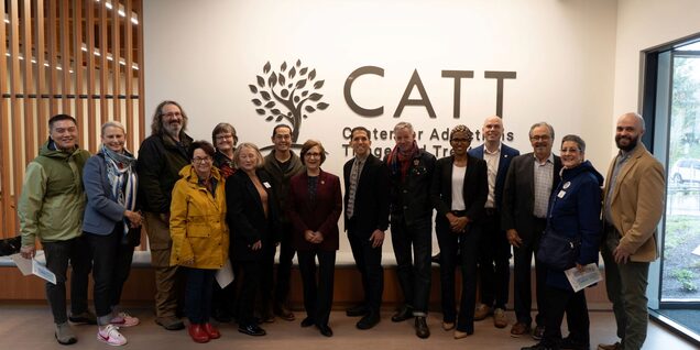 Large group of people in front of CATT sign