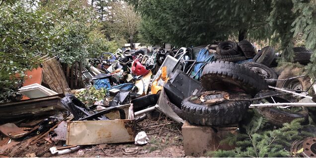 Tires and other garbage littering a property