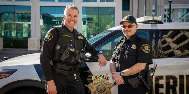 Reserves Ziggy Lopuszynski and Rod Cottis by patrol vehicle