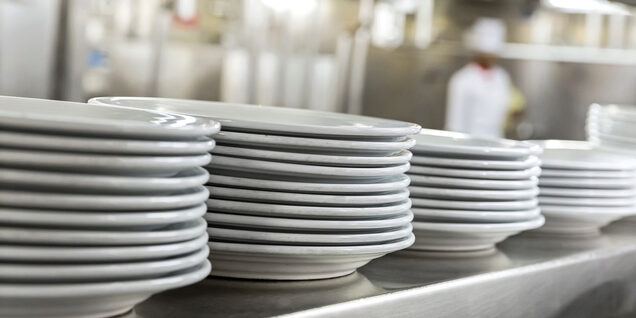 dinner plates stacked in restaurant line
