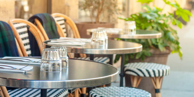 outdoor dining tables with glassware and place settings