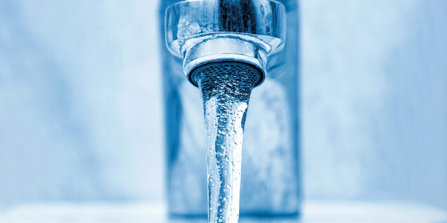 A close-up of water flowing from a tap.