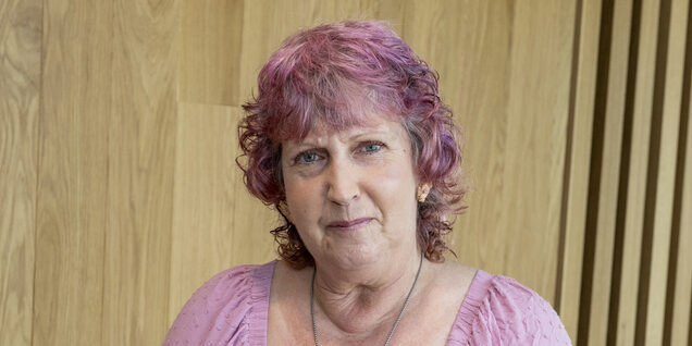 A portrait of a women standing for the camera