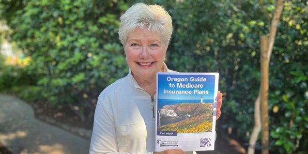 Smiling woman holds Medicare guide