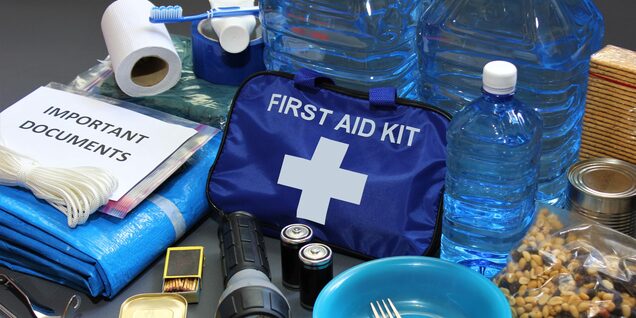 First aid kit, bottled water, flashlight and an assortment of other supplies in an emergency kit