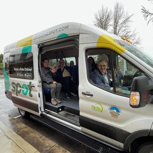 The SPOT shuttle has passengers inside shuttle. From left to right: City of Tigard Mayor Yi-Kang Hu, Washington County Commissioner Jason Snider, Beaverton Councilor Ashley Hartmeier-Prigg, Beaverton School District Safe Routes to School Coordinator Leah Biado-Luis, and in the front seat, Washington County Commissioner Jerry Willey.
