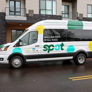 The SPOT shuttle van which is white with yellow, green and aqua polka dots sits in its dedicated pick up parking spot at Amity Orchards
