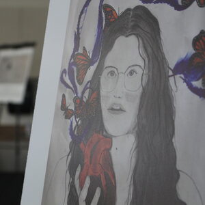 A creative poster showing a teenage girl hold a heart in her hand. 