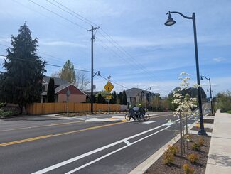 Two cyclists crossing Springville Road
