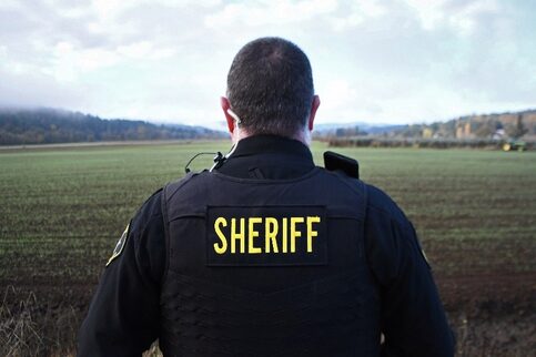 Sheriff Deputy looking across a field