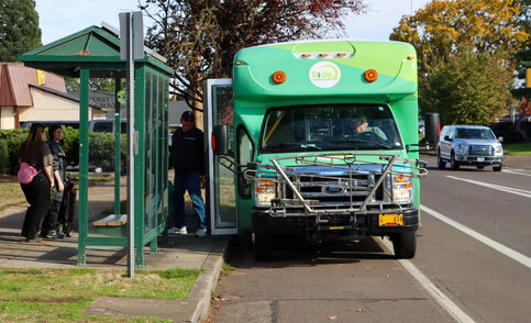 People boarding GroveLink community connector shuttle