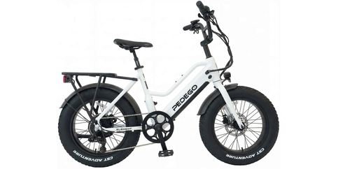 A white Class 2 electric bike with thick tires, a rear cargo rack, and front and rear fenders, shown from the side