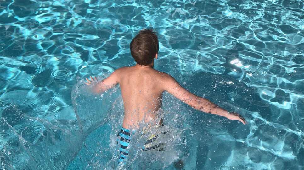 Boy swimming in pool