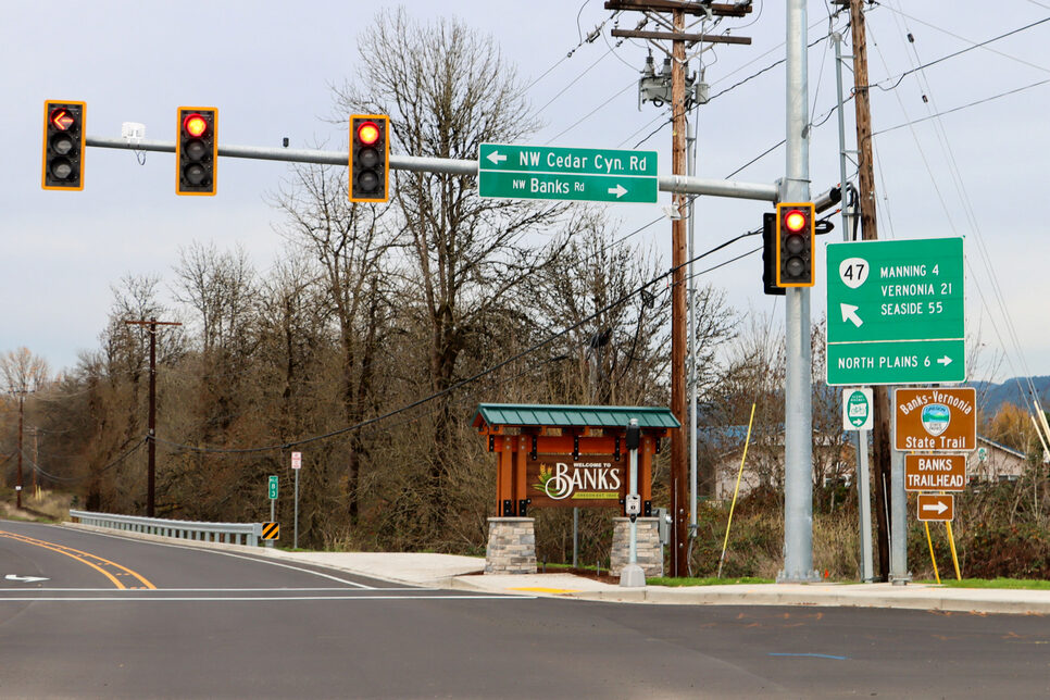Banks Road and Main Street intersection showing traffic signal and Welcome to Bankssign