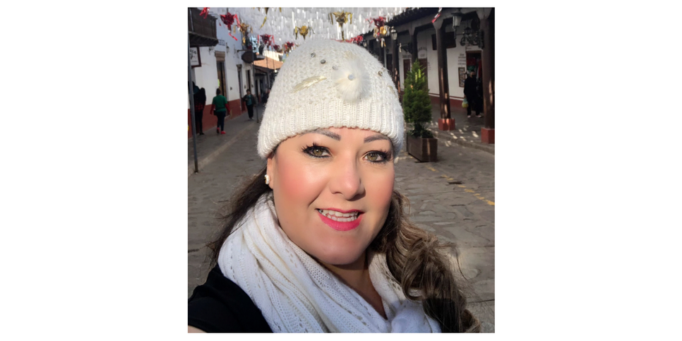 A woman wearing a white beanie and white scarf. 